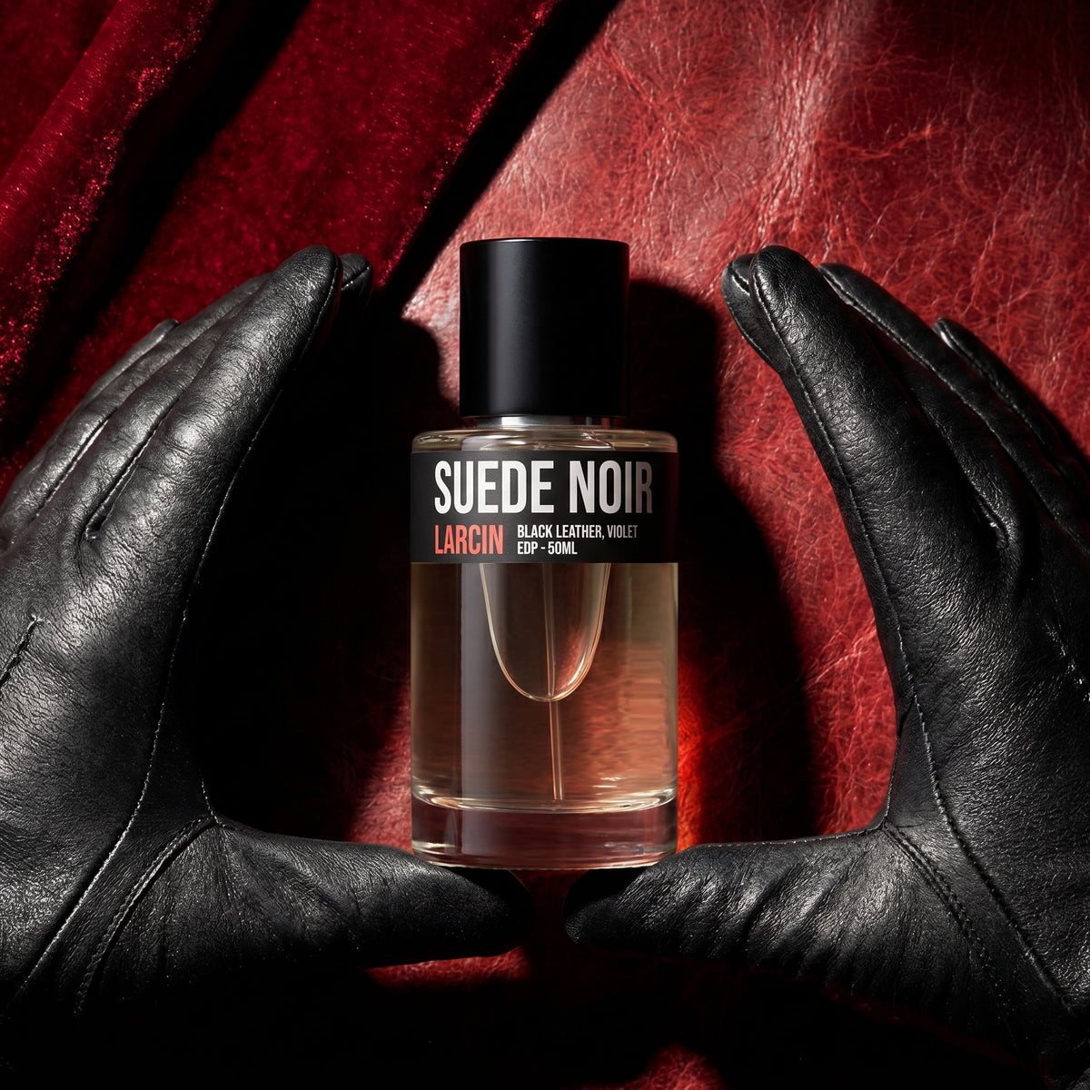 Larcin Suede Noir 50ml leather perfume held in black leather gloves